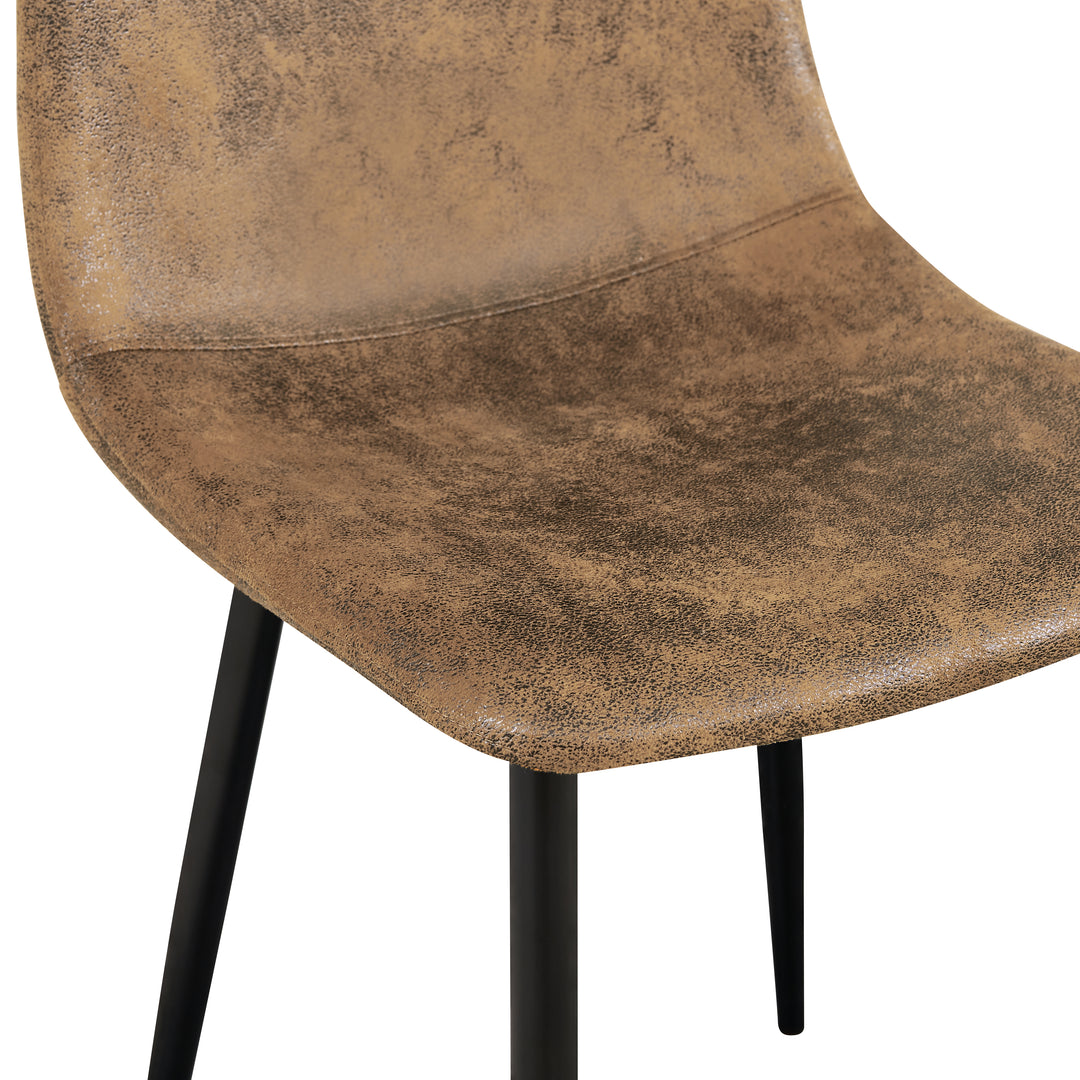 Set of four tan faux suede dining chairs with black metal legs. Curved shell supports the back and a slim frame saves space for kitchens, dining rooms, and apartments.